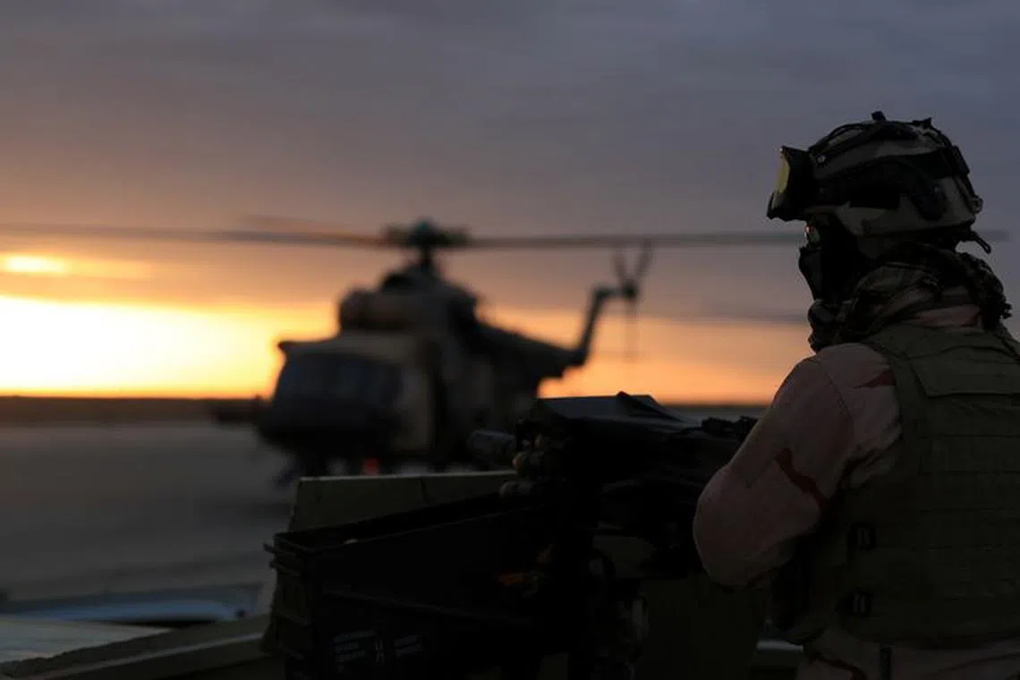 FILE PHOTO: A member of Iraqi security forces is seen at Ain al-Asad airbase in the Anbar province, Iraq December 29, 2019. REUTERS/Thaier Al-Sudani/File Photo