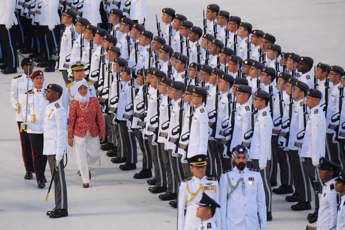 President Halimah Yacob inspecting the guard of honour during the National Day Parade at the Padang on Aug 9, 2023. ST PHOTO: MARK CHEONG