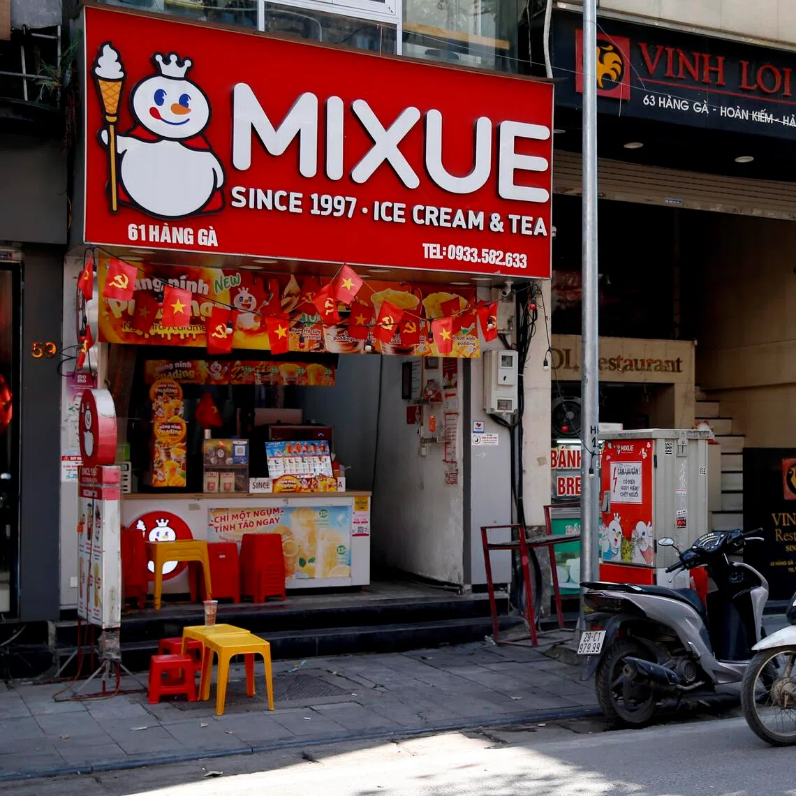 A man rides motorbike past a Mixue store in Hanoi, Vietnam, 25 November 2025.