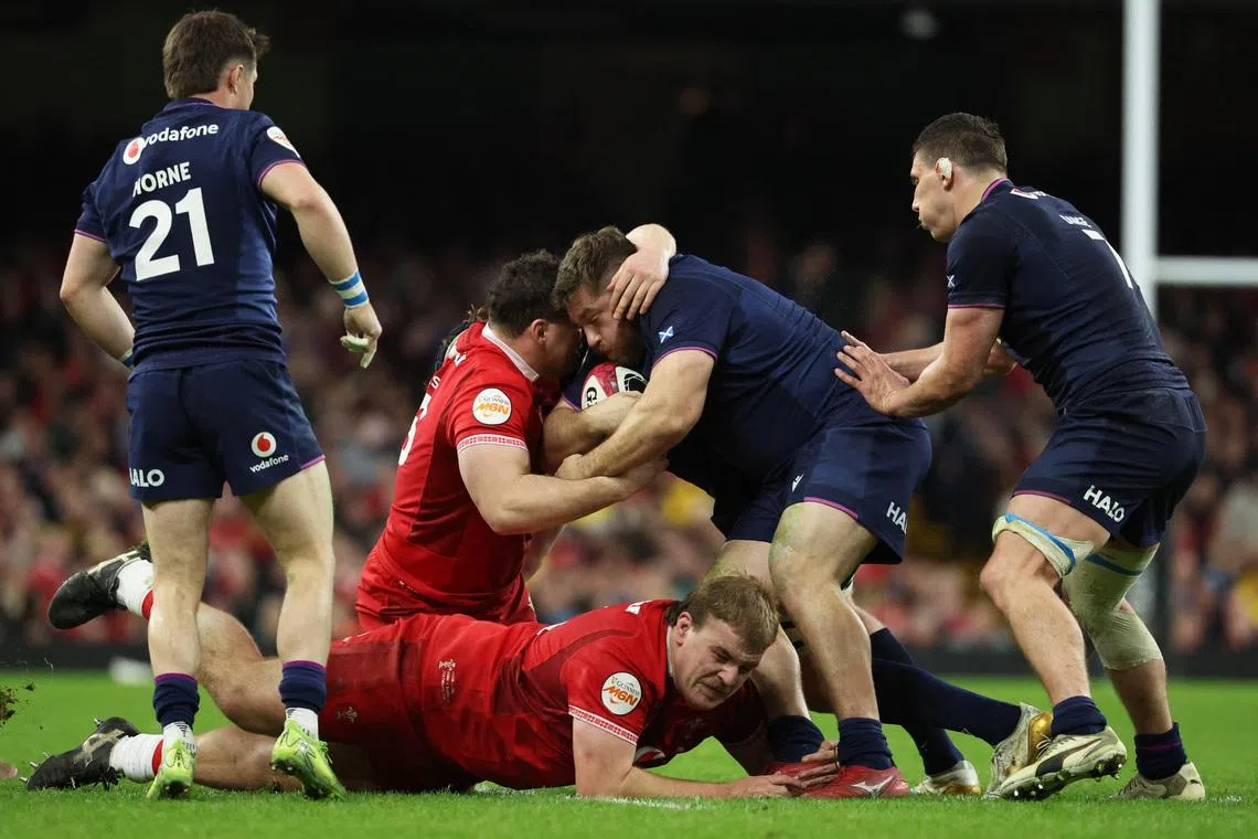 Rugby Union - Six Nations Championship - Wales v Scotland - Principality Stadium, Cardiff, Wales, Britain - February 21, 2026 Scotland's Elliot Millar Mills in action with Wales' Archie Griffin and Ryan Elias. REUTERS/Cat Goryn