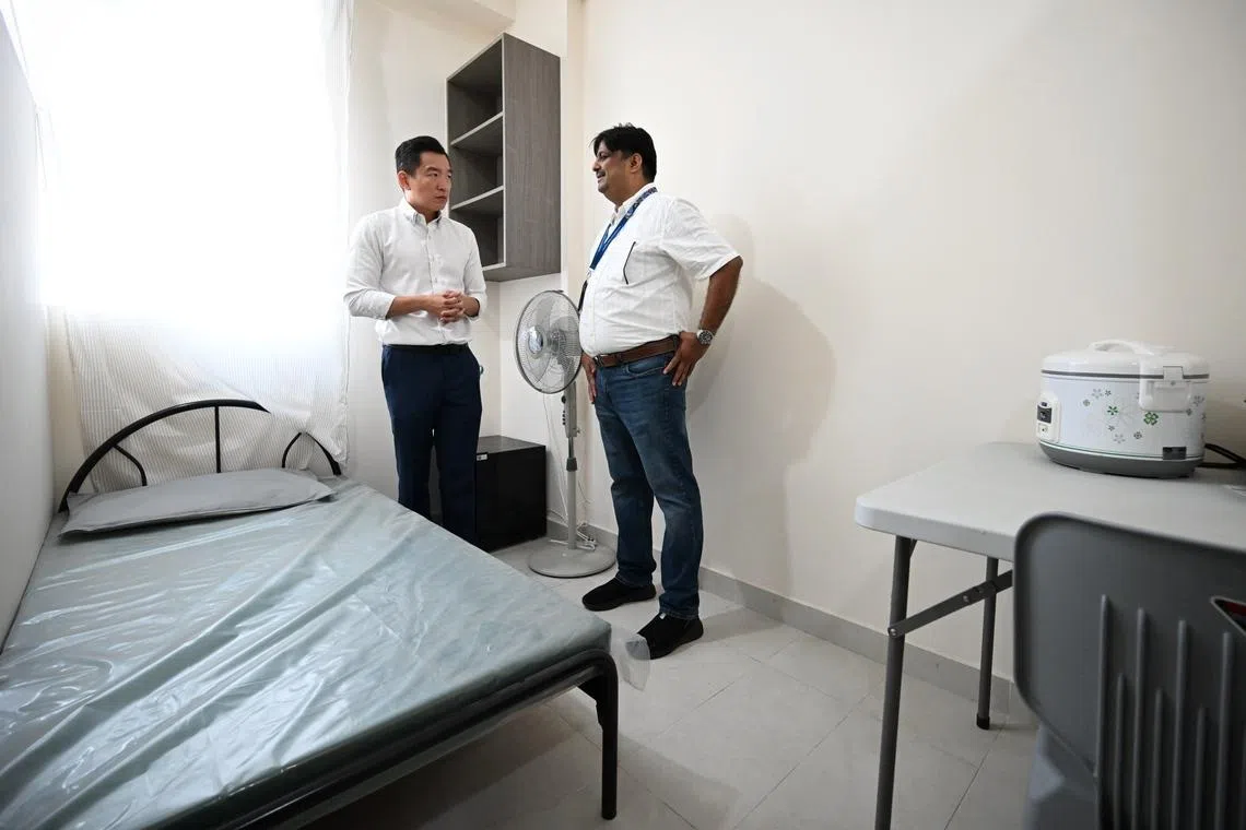 Senior Parliamentary Secretary for Social and Family Development Eric Chua (left) at the transitional shelter, Transit Point@Yio Chu Kang, on Jan 7.
