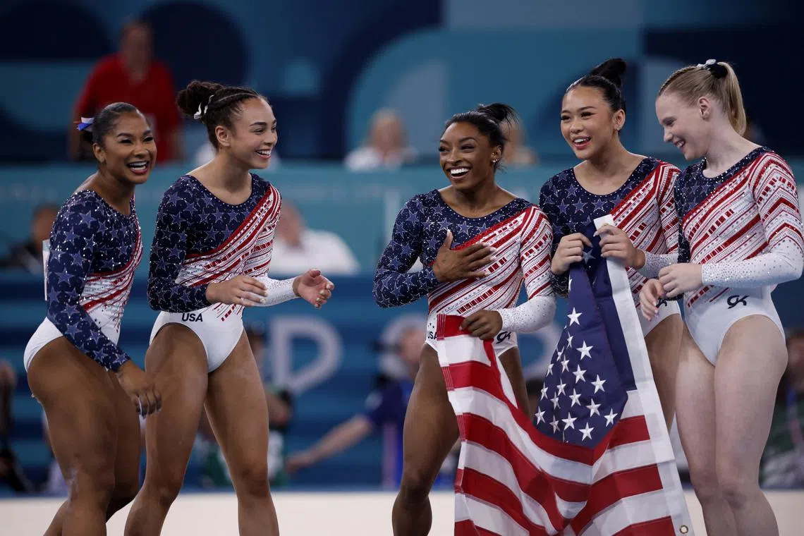 FILE PHOTO: Paris 2024 Olympics - Artistic Gymnastics - Women's Team Final - Bercy Arena, Paris, France - July 30, 2024. Simone Biles of United States, Jordan Chiles of United States, Jade Carey of United States, Sunisa Lee of United States and Hezly Rivera of United States celebrate after winning gold. REUTERS/Amanda Perobelli/File Photo