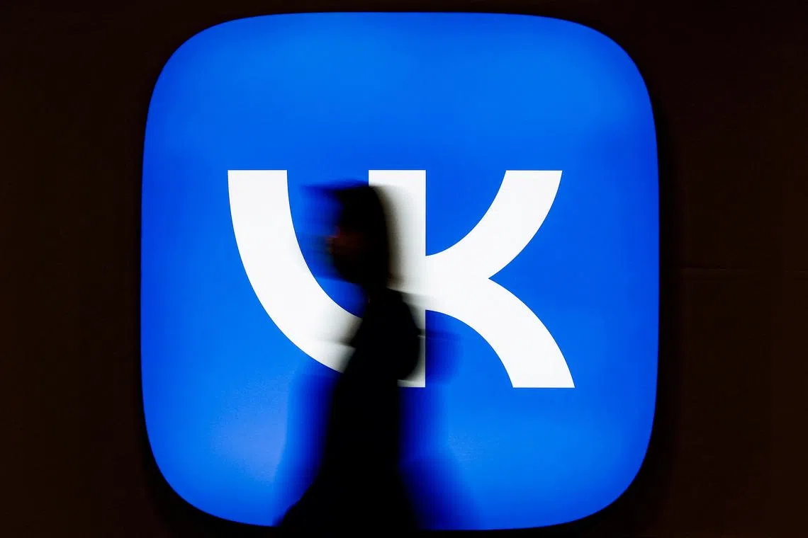 FILE PHOTO: An employee of Russian internet company VK walks past the company's logo at its headquarters in Moscow, Russia January 21, 2022. REUTERS/Maxim Shemetov/File Photo