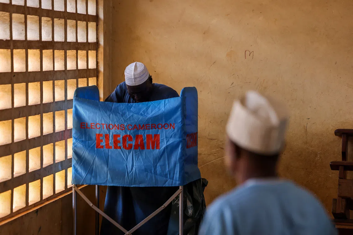 A man votes during the presidential election, in Yaounde, Cameroon October 12, 2025. REUTERS/Zohra Bensemra