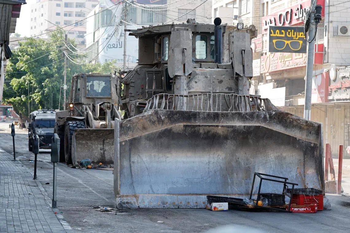 A military bulldozer operates during an Israeli raid in Jenin, in the Israeli-occupied West Bank June 13, 2024. REUTERS/Raneen Sawafta