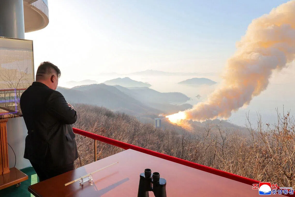 This undated picture released by North Korea's official Korean Central News Agency (KCNA) on March 29, 2026 showing North Korean leader Kim Jong Un inspecting a combustion test of a solid-fuel rocket engine at an undisclosed location in North Korea. 