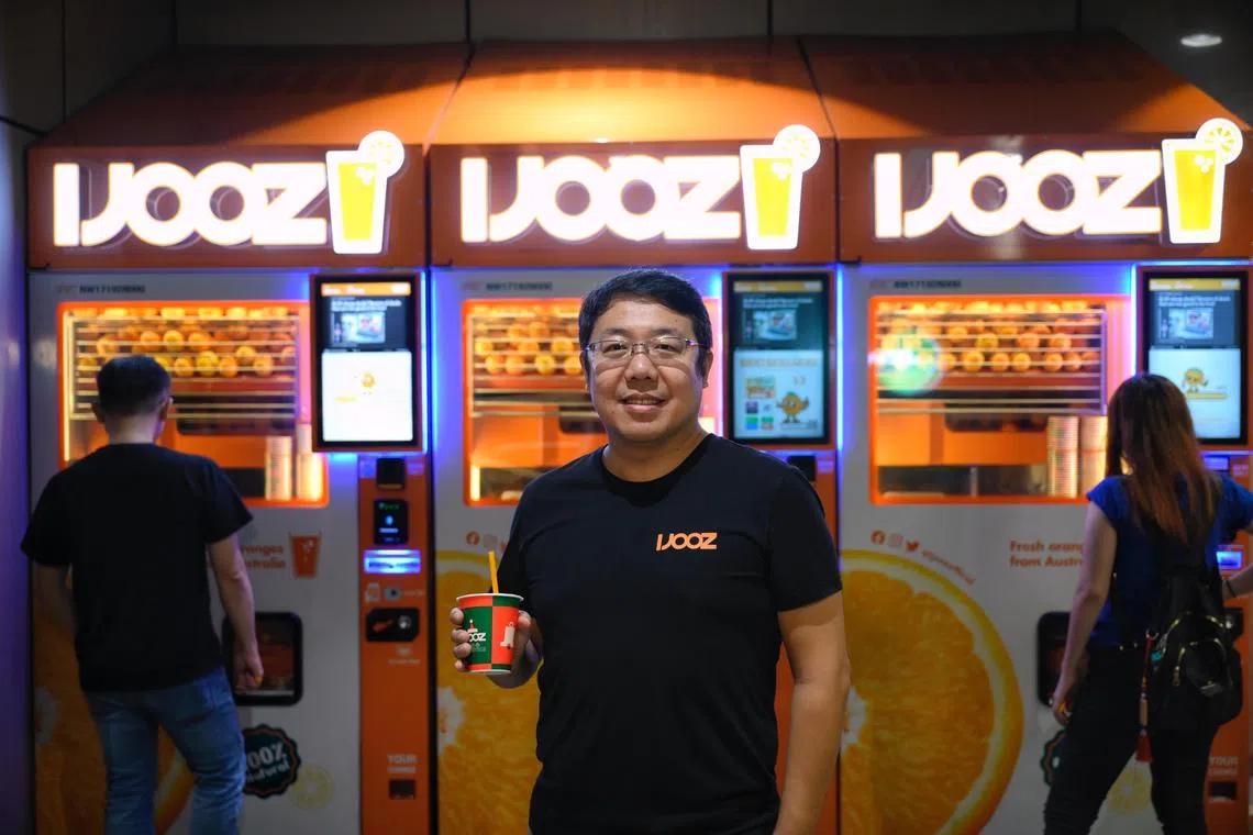 iJooz chief executive Bruce Zhang in front of a row of vending machines at Yishun Bus Interchange. The company aims to install 5,000 machines across Singapore in total. 