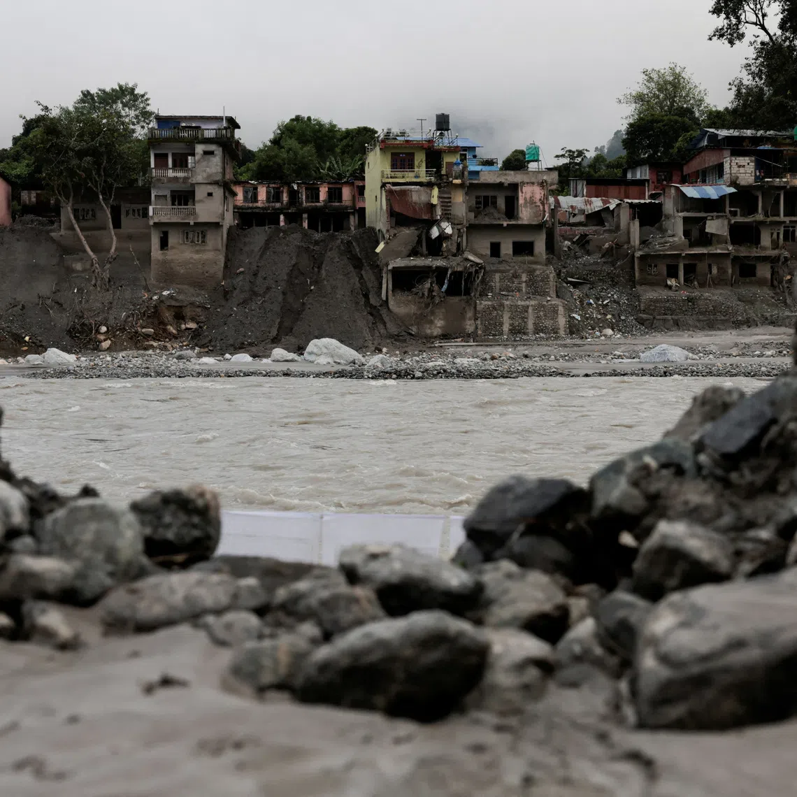 A file photo of damaged houses following deadly flash floods and a mudslide, in Devighat, Nepal, on Sept 21.