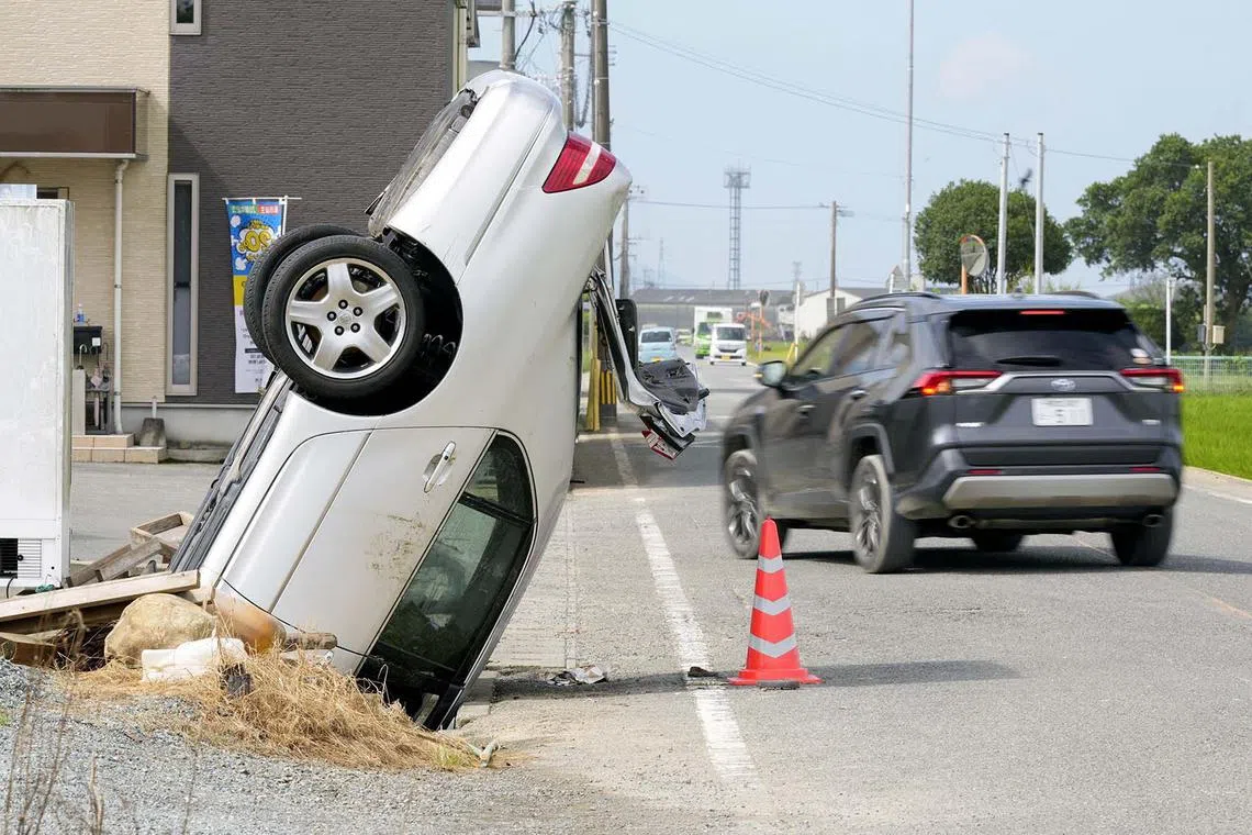 A vehicle is stuck in an irrigation channel following days of torrential rain in Yatsushiro, Kumamoto Prefecture, southwestern Japan, August 12, 2025, in this photo taken by Kyodo. Mandatory credit Kyodo/via REUTERS ATTENTION EDITORS - THIS IMAGE WAS PROVIDED BY A THIRD PARTY. EDITORIAL USE ONLY. MANDATORY CREDIT. JAPAN OUT. NO COMMERCIAL OR EDITORIAL SALES IN JAPAN. TPX IMAGES OF THE DAY