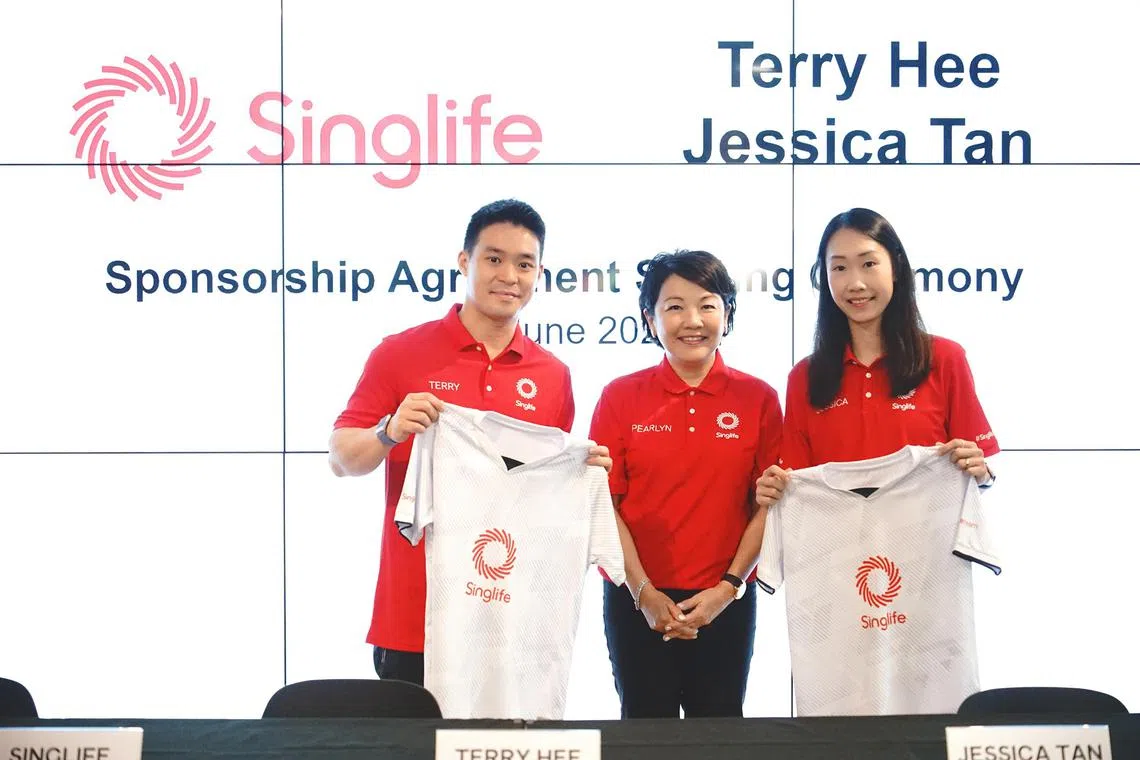 dlbad20 - Singapore badminton mixed doubles duo Terry Hee and Jessica Tan with Singlife group chief executive officer Pearlyn Phau (centre) after the Olympic-bound athletes signed a sponsorship deal with the homegrown financial services company on June 20.

Credit: Singlife