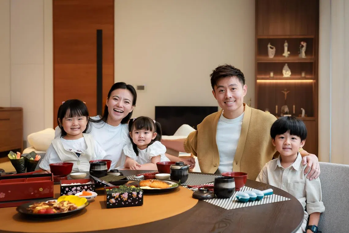 Parents Cheryl Wee and Roy Fong, both 36, with their children Marc (right), 5, Emma (left), 4, and Elly (centre), 2, having their meal in their home, Jan 7, 2024.