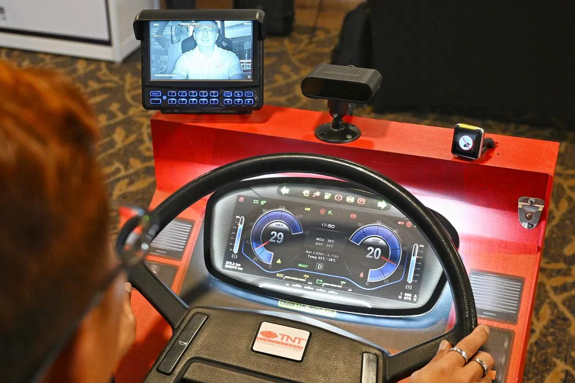Senior bus captain Guek Peng Kian, 47, demonstrating the use of Golden Eye, a  fatigue monitoring system for bus captains, which has the capability to detect a bus captain’s lack of focus on the road by sending audio visual alerts to him/her in the driver's cabin. Uniquely, it sends haptic alerts which causes the Bus Captain's seat to vibrate to draw his/her attention.