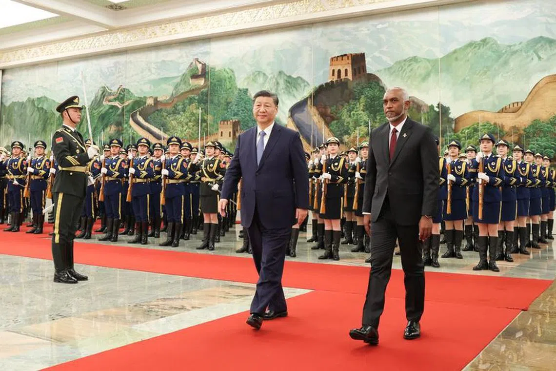 Chinese President Xi Jinping and Maldivian President Mohamed Muizzu attend a welcome ceremony at the Great Hall of the People in Beijing, China January 10, 2024. cnsphoto via REUTERS