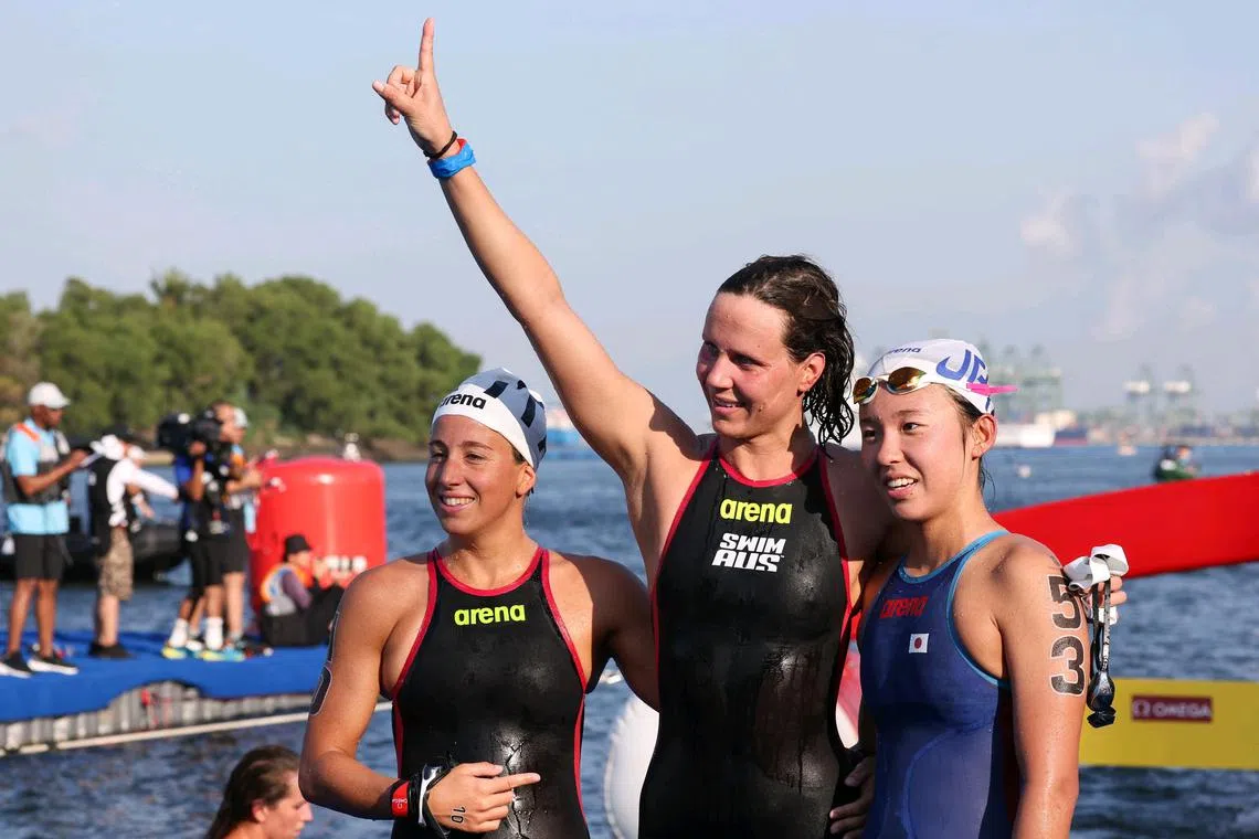 ST20250718_202595000382/dgswim18/Brian Teo/Deepanraj A C Ganesan/Australian swimmer Moesha Johnson striking a pose alongside second-place finisher, Italian swimmer Ginevra Taddeucci, and third-place finisher, Japanese swimmer Ichika Kajimoto, following her victory in the Women's 5km Open Water event at the World Aquatics Championships in Sentosa on July 18, 2025 ST PHOTO: BRIAN TEO