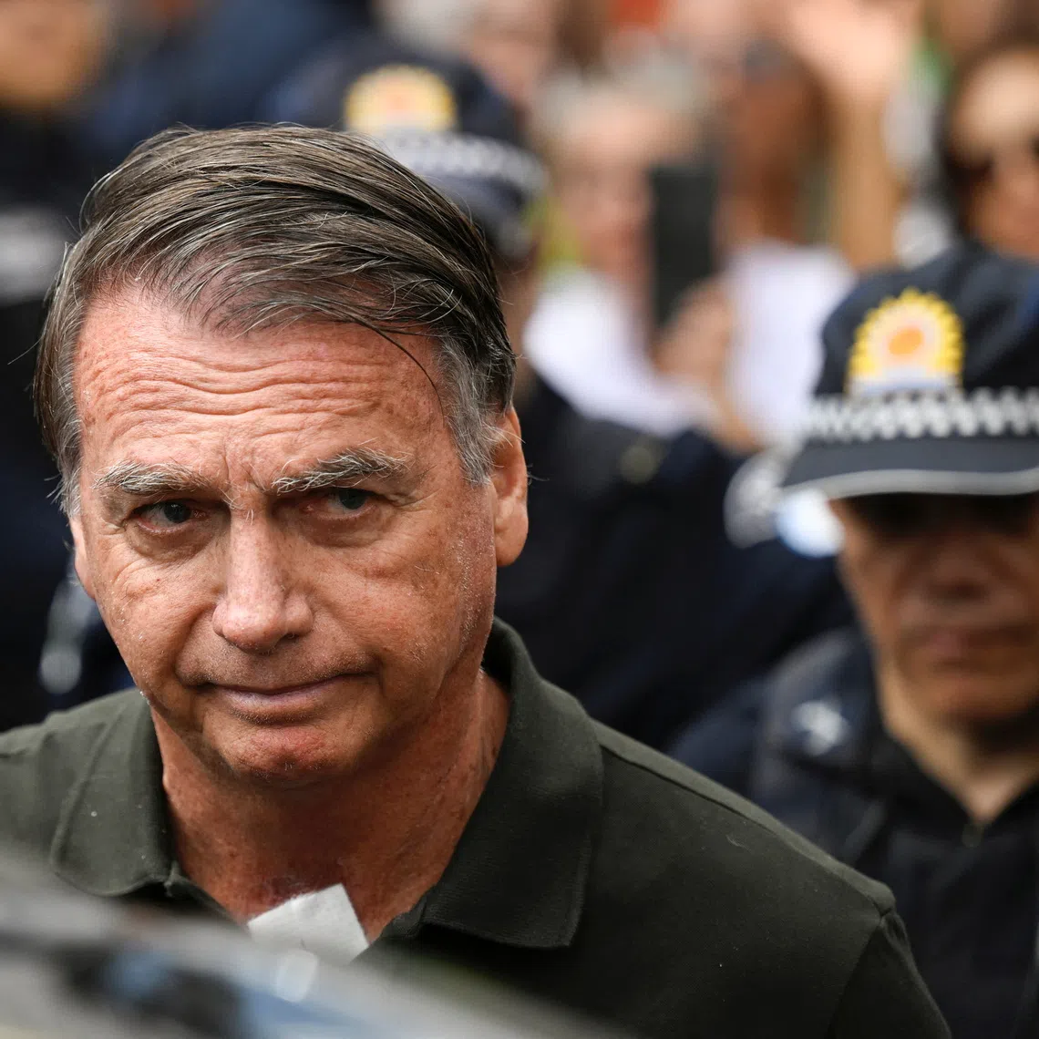 Former Brazilian President Jair Bolsonaro leaves the hospital where he went to undergo a skin surgery procedure, authorized by Supreme Court Justice Alexandre de Moraes, leaving the house arrest after being convicted by a Supreme Court majority of plotting a coup to remain in power after losing the 2022 election, in Brasilia, Brazil, September 14, 2025. REUTERS/Mateus Bonomi