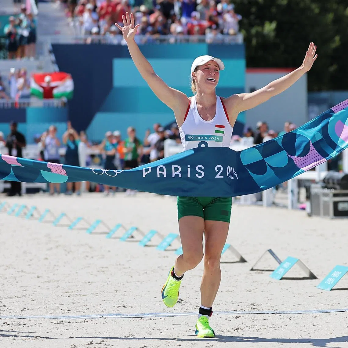 Michelle Gulyas of Hungary reacts as she crosses the finish line of the final laser run in the women's modern pentathlon at the Paris Olympics in Versailles on Aug 11, 2024.