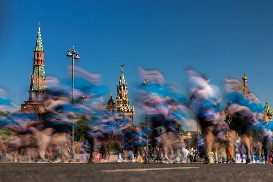 People running in front of towers of the Kremlin and St. Basil’s Cathedral during a running festival in Moscow, Russia on May 19, 2024. 