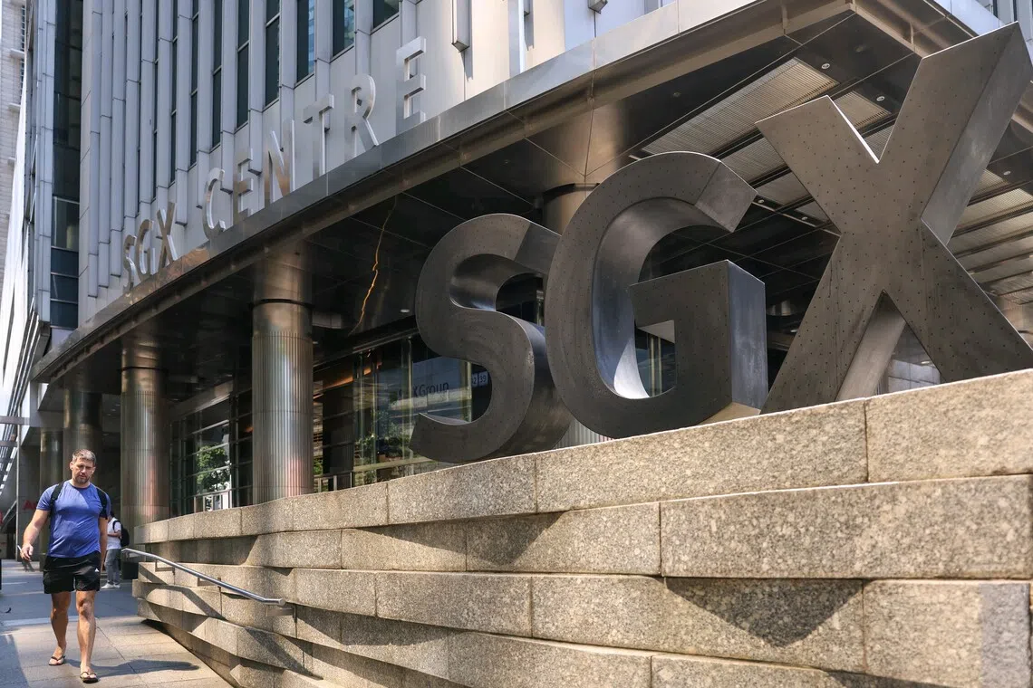 Pixgenerics / A passer-by walking past the SGX logo outside SGX Centre on April 10, 2025. Can be used for stories on SGX, stock market, STI, Trump, tariffs, investment, Singapore index, recession, shares. 