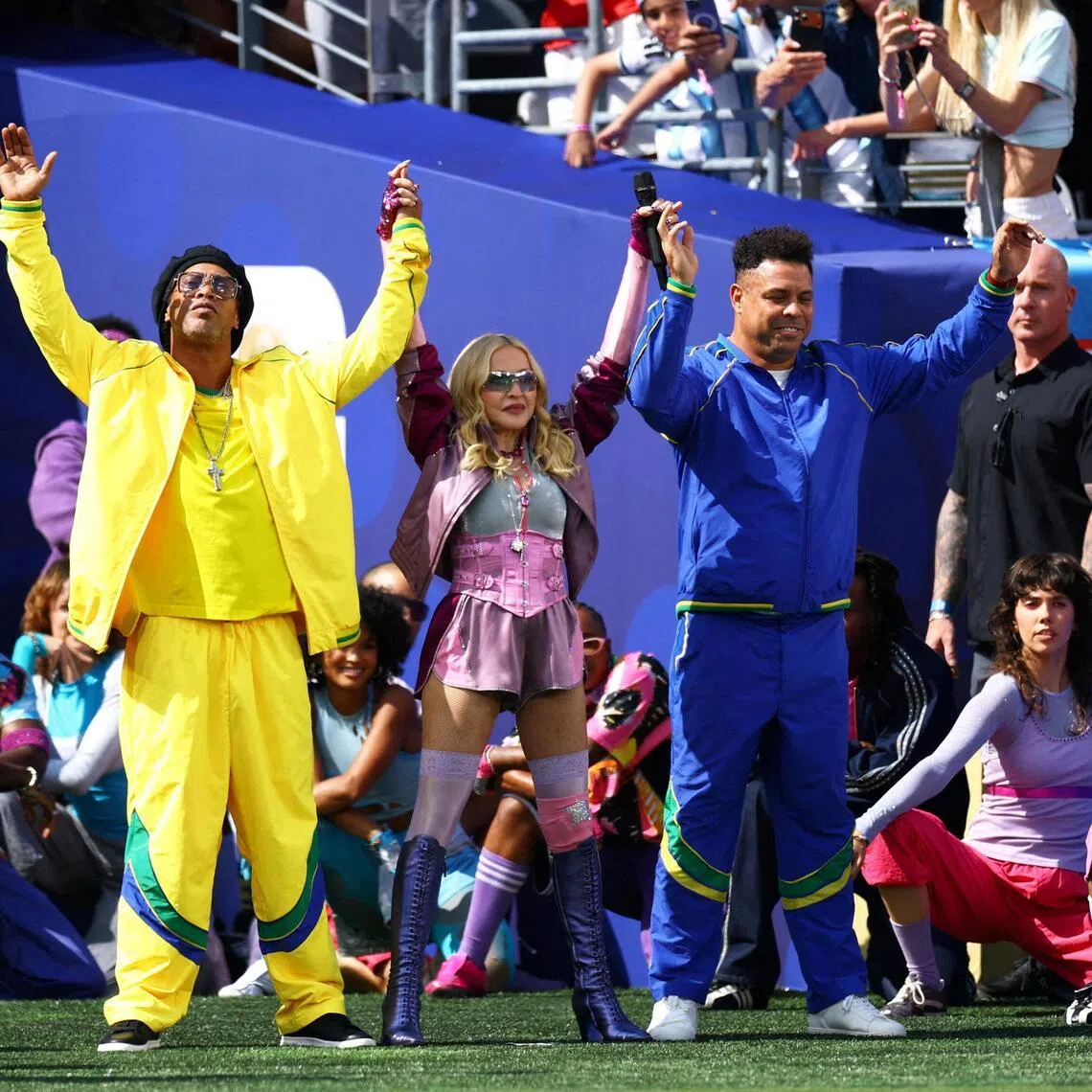 Former Brazil football players Ronaldinho (left) and Ronaldo (right) with Madonna (centre) during the World Cup final halftime show.
