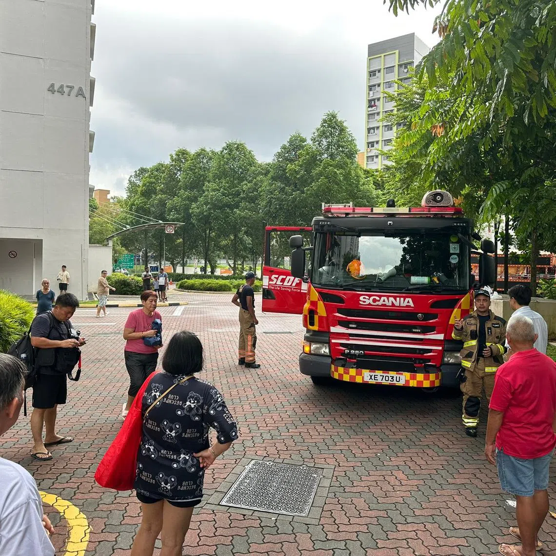 Residents outside the block after an electrical riser caught fire.