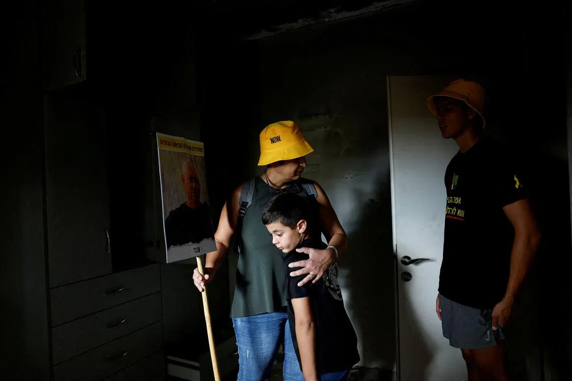 FILE PHOTO: Relatives of Ilan Weiss, a victim of the October 7 attack by Hamas, gather at his burned home during a ceremony marking one year since the deadly attack, in Kibbutz Beeri, southern Israel, October 7, 2024. Reuters/Amir Cohen/File Photo