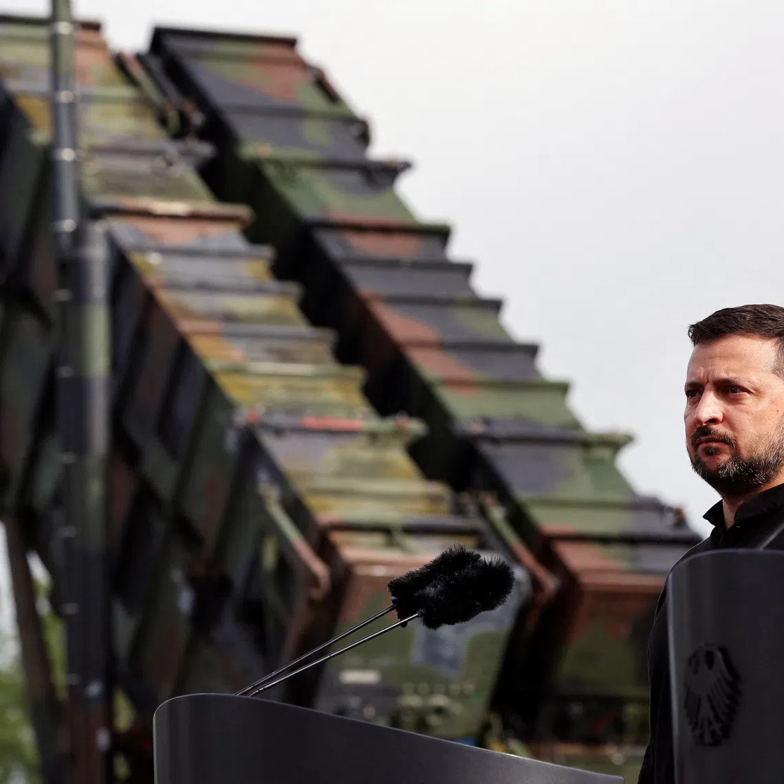 FILE PHOTO: Ukrainian President Volodymyr Zelenskiy looks on during a visit to a military training area to find out about the training of Ukrainian soldiers on the “Patriot” anti-aircraft missile system, at an undisclosed location, in Germany, June 11, 2024.   Jens Buttner/Pool via REUTERS/File Photo