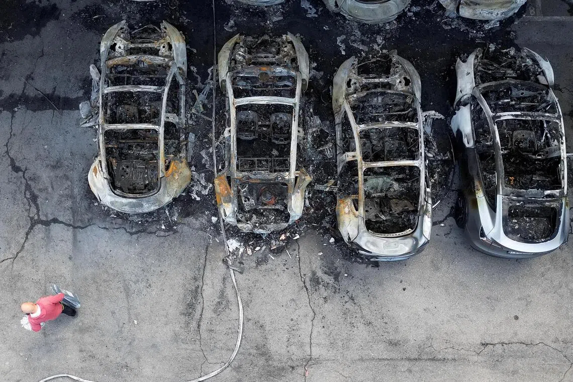 A drone view shows charred Tesla vehicles following a fire at a Tesla dealership that destroyed vehicles, in Rome, Italy, March 31, 2025. REUTERS/Yara Nardi     TPX IMAGES OF THE DAY     