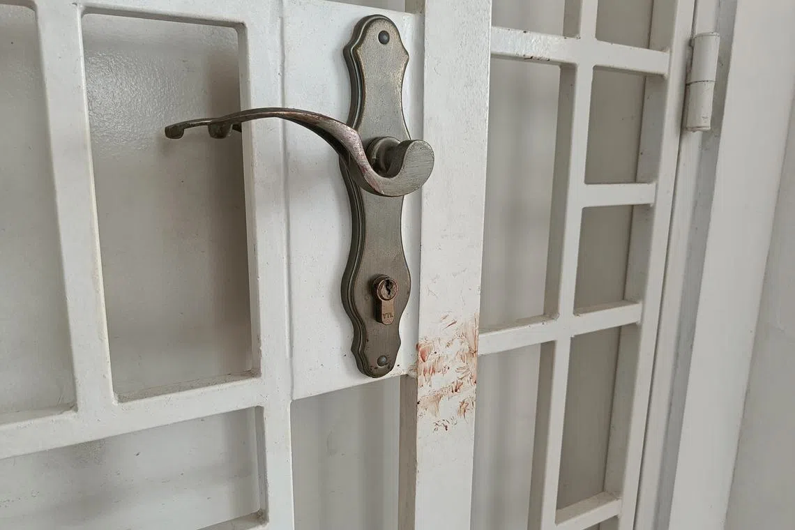 Bloodstains on the gate of the flat where victims of the knife attack lived.
