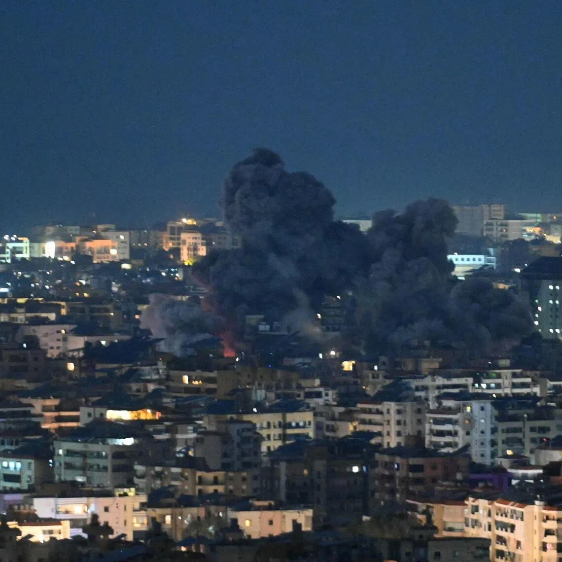 Fire blazes and black smoke rises from the site of an Israeli airstrike that targeted the office of the Hezbollah affiliated Al-Manar TV station in Beirut’s southern suburb of Haret Hreik on March 3, 2026.  
