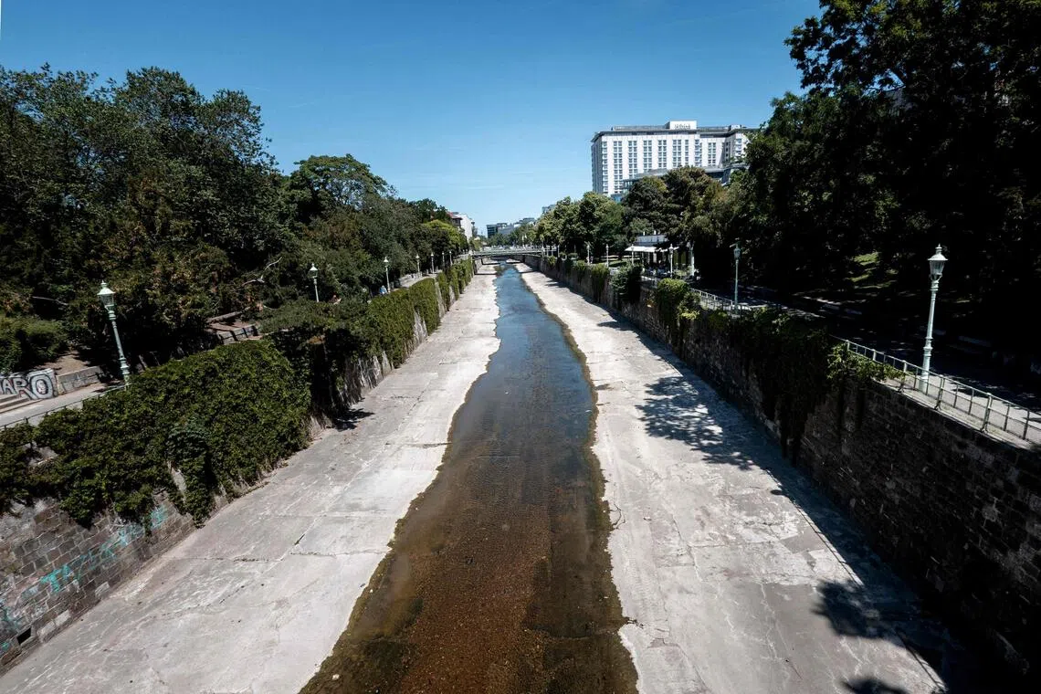 A very low water level of the river Wienfluss (Vienna river) cutting through the City park (Stadtpark) is seen on a sunny and hot day in Vienna, Austria, on May 28.