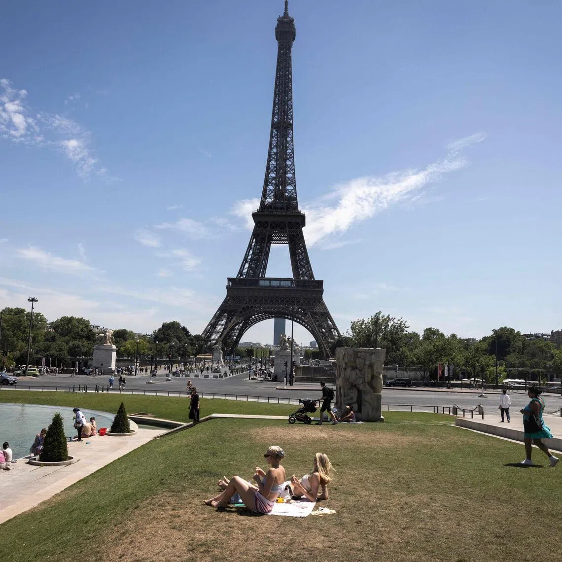 Women sunbathe at the Jardin du Trocadero, near the Eiffel Tower in Paris on July 10 as a new heatwave hits France.