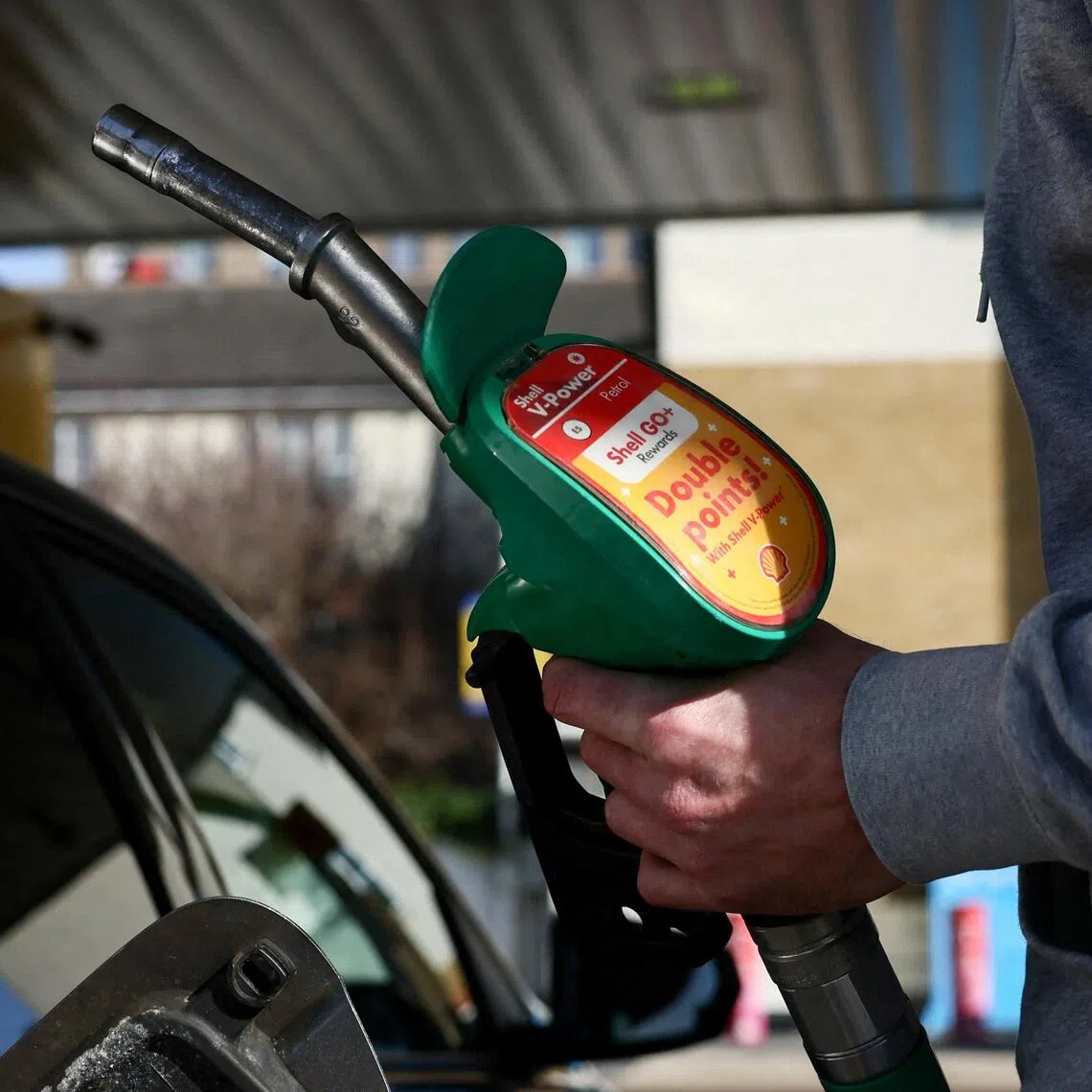 A motorist filling his car with fuel in Britain on March 5, a week after the US and Israel launched attacks on Iran.