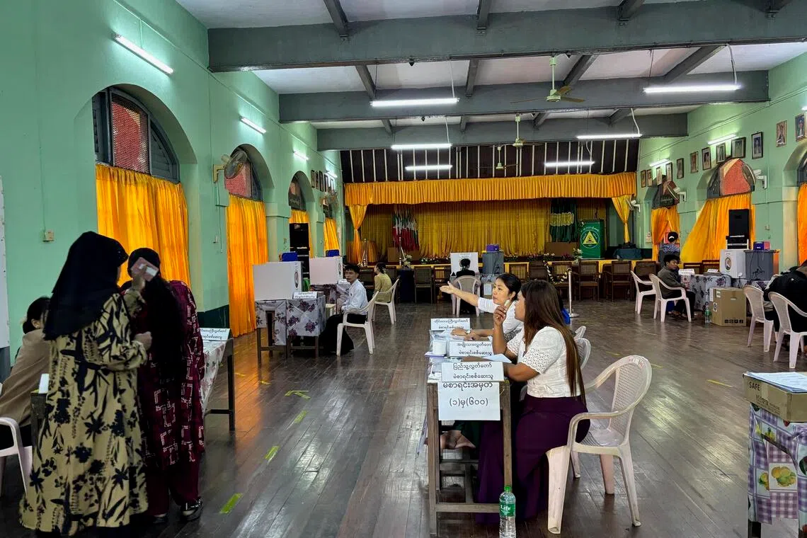 Voters attend a polling station at a high school in Yangon for the second phase of the regime-held general elections in Myanmar on Jan 11.