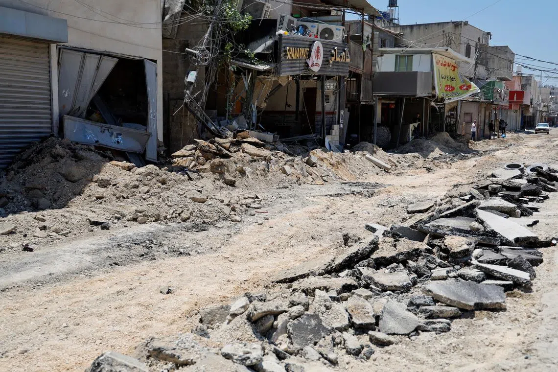 FILE PHOTO: People stand on a street after an Israeli raid at Nur Shams camp, in Tulkarm, in the Israeli-occupied West Bank, July 1, 2024. REUTERS/Raneen Sawafta/File Photo