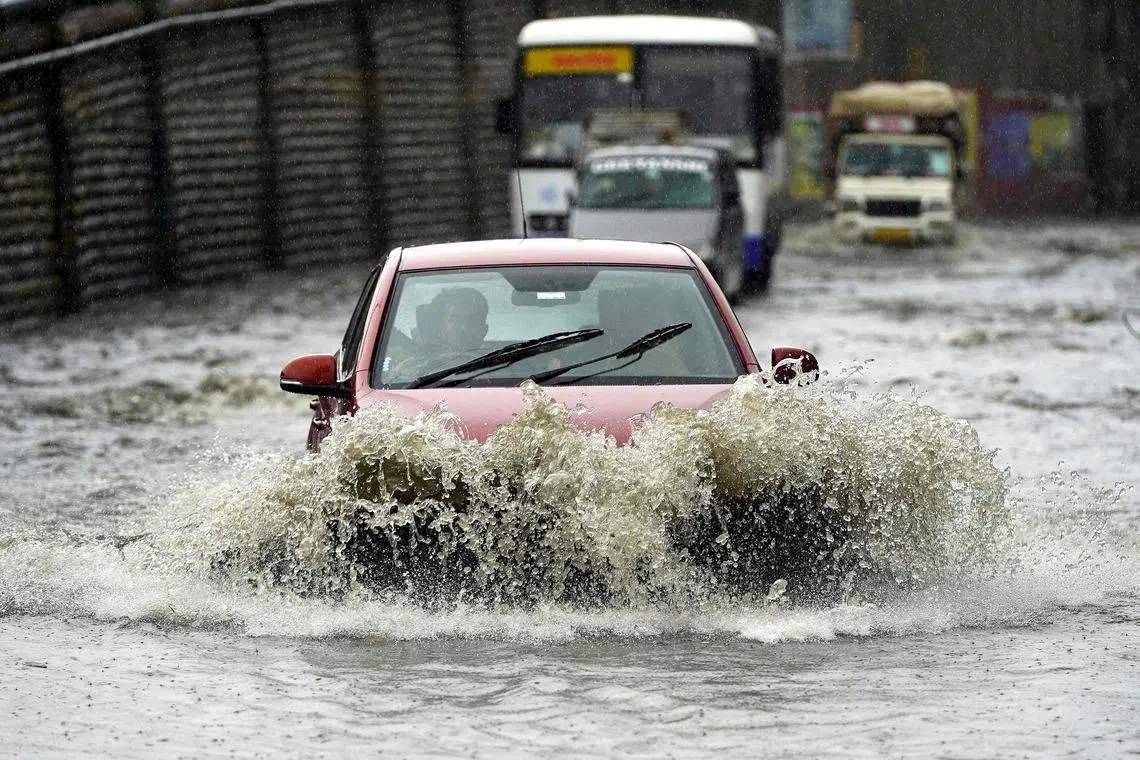 Vehicles wade through a waterlogged street after heavy monsoon rains in Ajmer, India, on July 22.