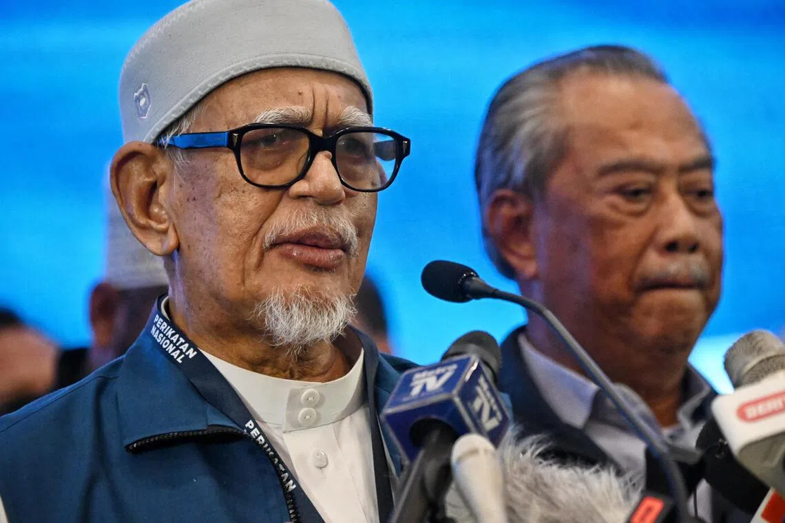 PAS president Abdul Hadi Awang with Perikatan Nasional (PN) chairman Muhyiddin Yassin after the results for Malaysia's 15th general election (GE15) at the Glenmarie Golf And Country Club in Kuala Lumpur on 19 Nov 2022.