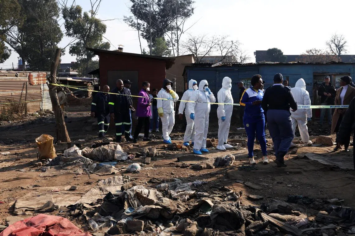 Members of the forensics team arrive at the scene after, according to the police, gunmen opened fire at an informal settlement in Cleveland, Johannesburg, South Africa,  June 10, 2026. REUTERS/Siphiwe Sibeko
