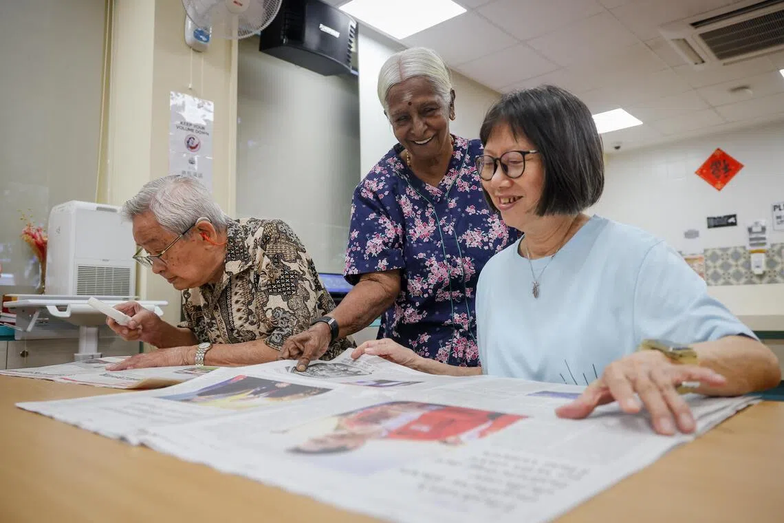 Madam Ratnam Periowsamy discussing the news with Ms Judy Lim, 74, and Mr Lee Ping, 95, at the Care Corner Active Ageing Centre in Toa Payoh East on Jan 12.