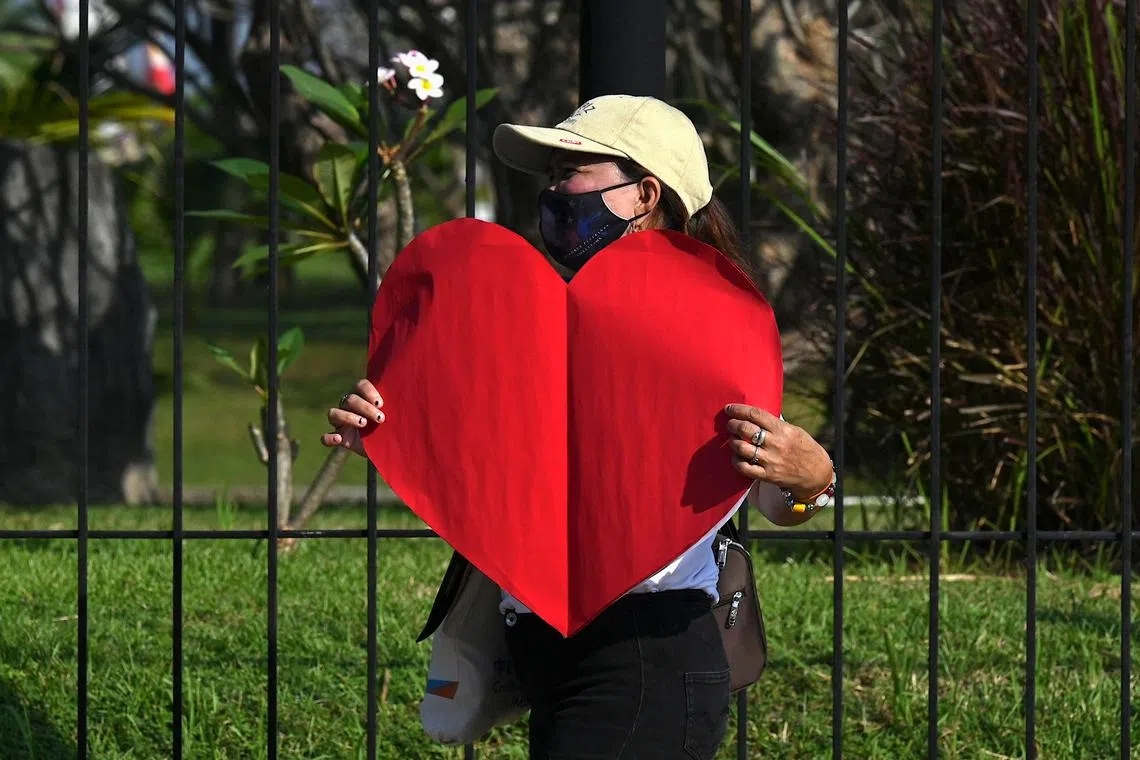 This photo taken on February 14, 2023 shows a pro-divorce protester taking part in a demonstration on Valentine's Day in front of the Senate Building in Pasay, Metro Manila. The Philippines is the only place outside the Vatican where divorce is outlawed, with the Catholic Church -- which holds great influence on Philippine society -- opposing the practice as against its teachings. (Photo by JAM STA ROSA / AFP) / To go with "Philippines-divorce-religion-politics", FOCUS by Ara Eugenio