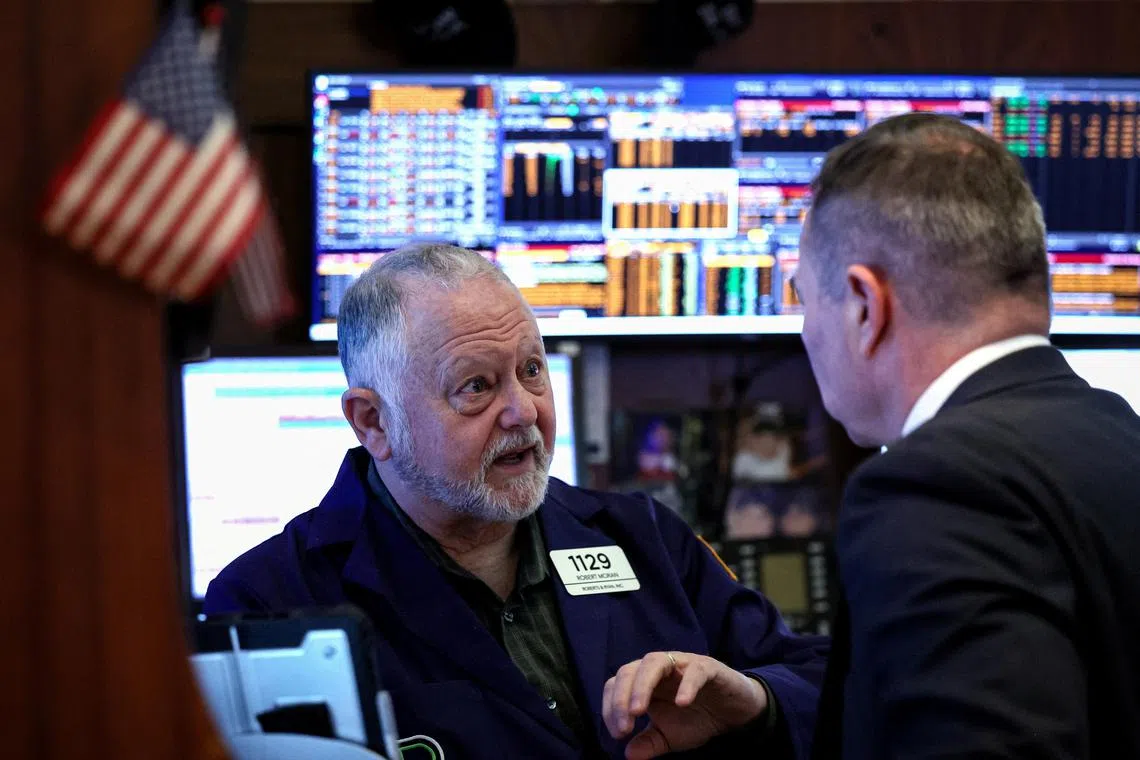 Traders work on the floor of the New York Stock Exchange, in New York City.