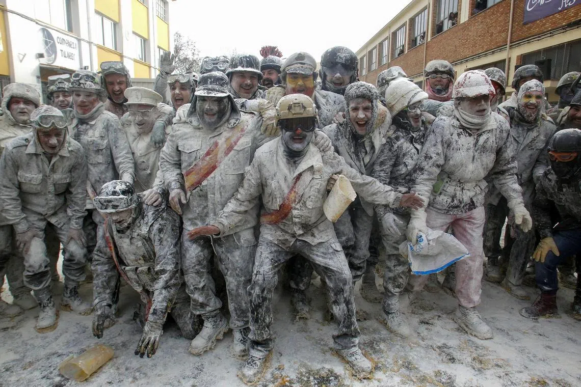 People dressed in miltary costumes taking part in a fake coup d'etat performances during the traditional fest called 'The floured ones' (Els Enfarinats) held in the village of Ibi, Alicante, Spain, Dec 28, 2023. 