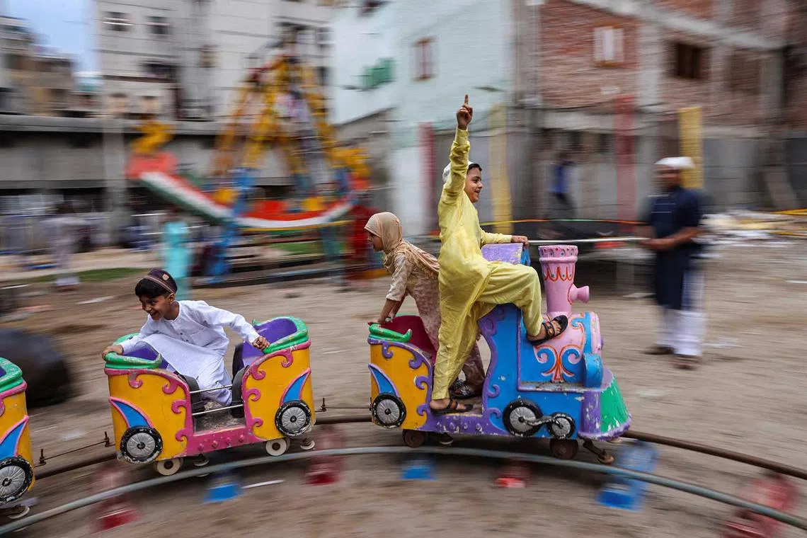 Children play on a toy train at a park on the occasion of Eid al-Adha festival, in the old quarters of Delhi, India, June 29.