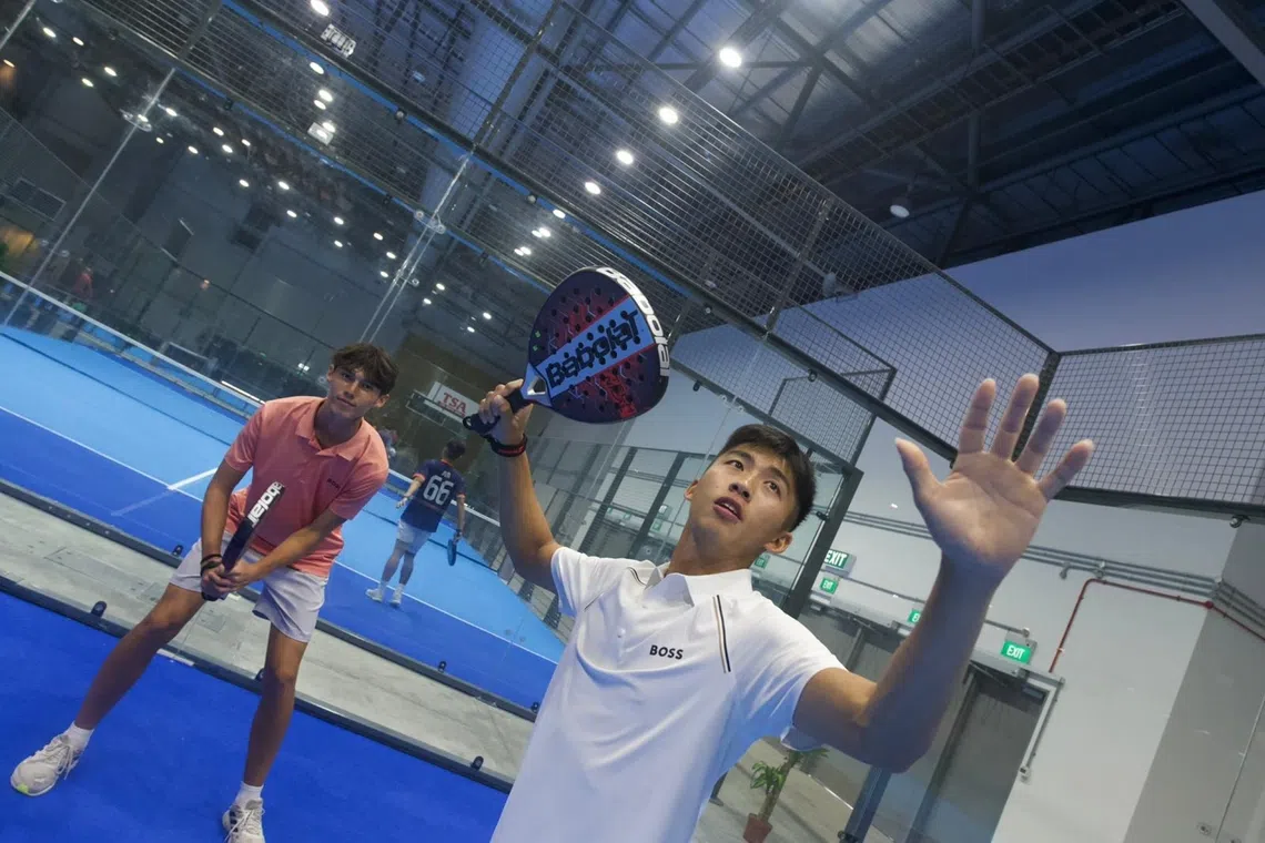 Sean Lee (foreground) about to smash in padel game with Troy Storm against Bill Chan and Ethan Brown.