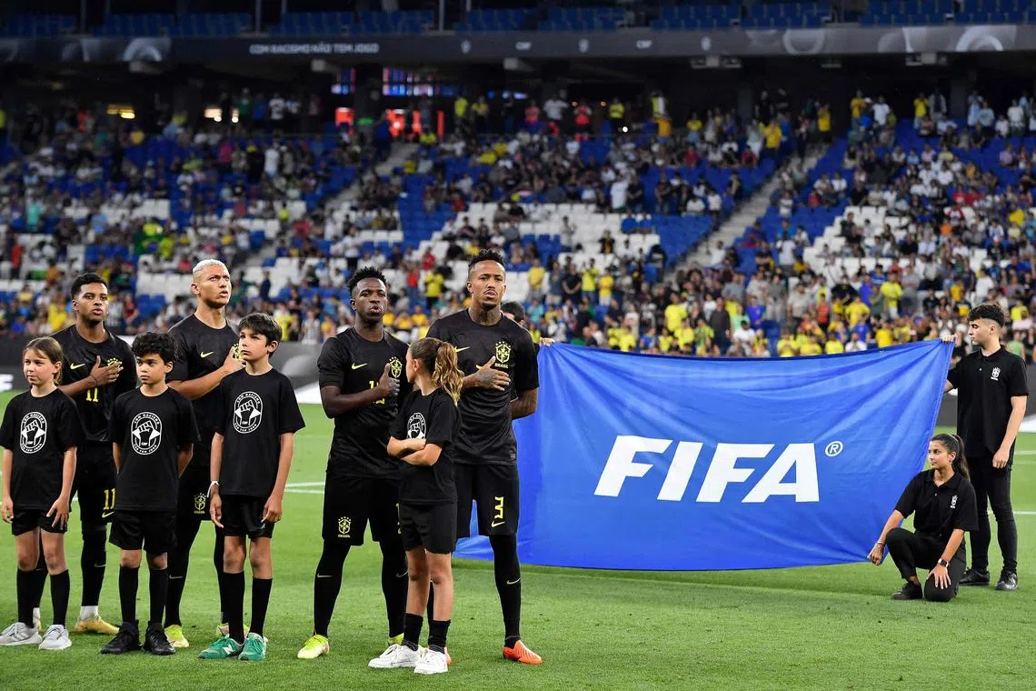 (From L) Brazil's forward Rodrygo, Brazil's forward Richarlison, Brazil's forward Vinicius Junior and Brazil's defender Militao line up for national anthems before the start of the international friendly football match between Brazil and Guinea at the RCDE Stadium in Cornella de Llobregat near Barcelona on June 17, 2023. (Photo by Pau BARRENA / AFP)