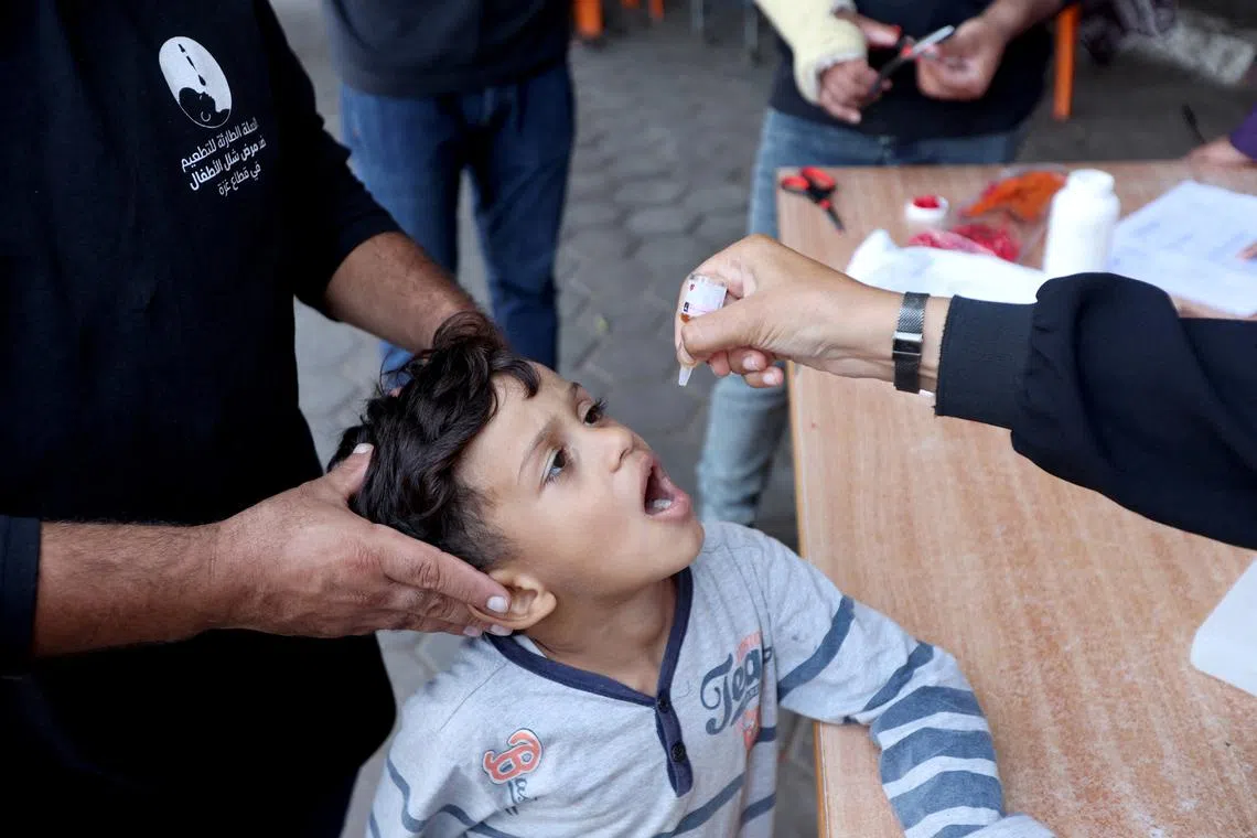 FILE PHOTO: Palestinian child is vaccinated against polio during the second round of a vaccination campaign, amid the Israel-Hamas conflict, in Deir Al-Balah in the central Gaza Strip, October 14, 2024. REUTERS/Ramadan Abed/File Photo