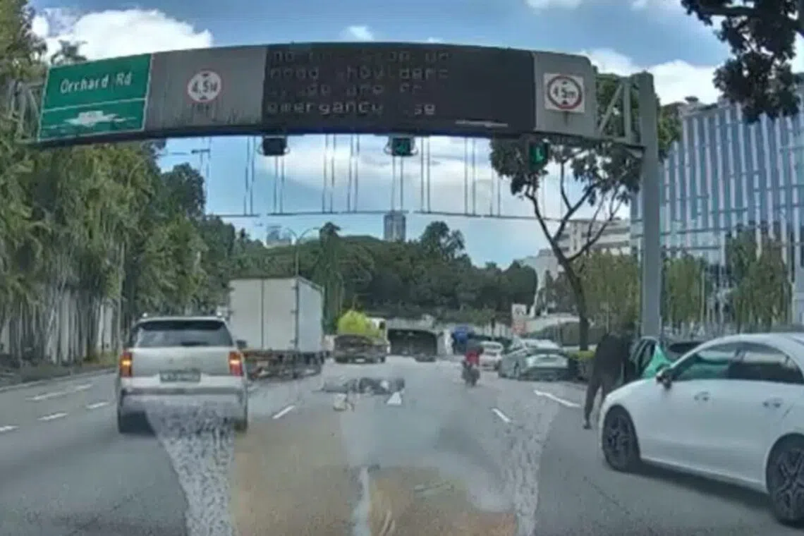The motorcyclist and pillion rider appear to be lying on the CTE near the Orchard Road exit.