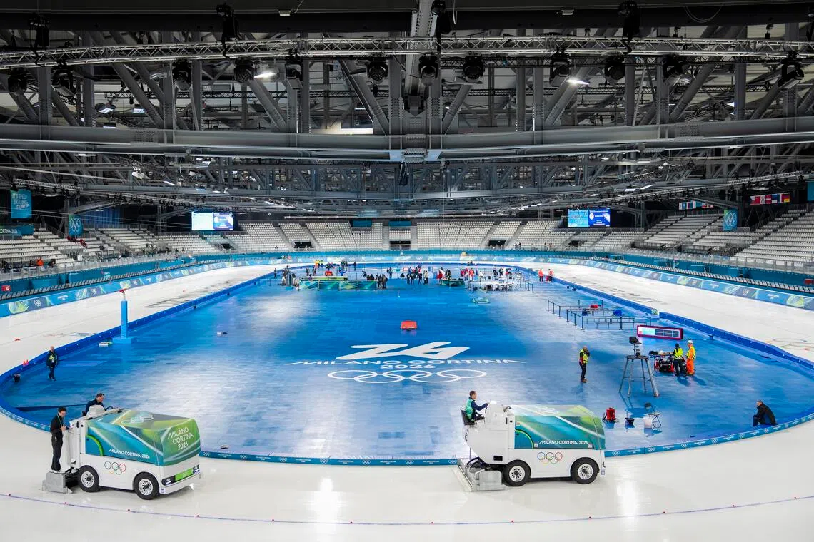 Workers resurface the ice at the speed skating stadium, a temporary venue, ahead of the 2026 Milan-Cortina Winter Olympics in Milan.