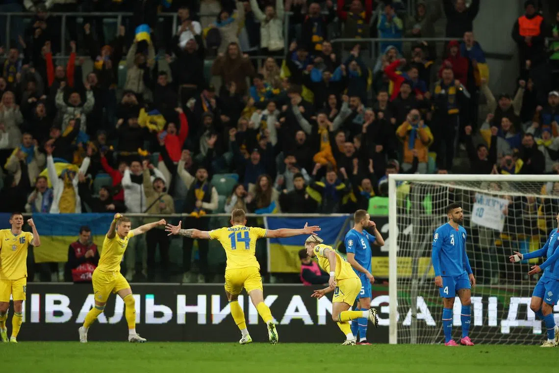 Soccer Football - Euro 2024 Qualifier -Play-Off- Ukraine v Iceland - Stadion Miejski Wroclaw, Wroclaw, Poland - March 26, 2024 Ukraine's Mykhailo Mudryk celebrates scoring their second goal with Volodymyr Brazhko REUTERS/Kacper Pempel