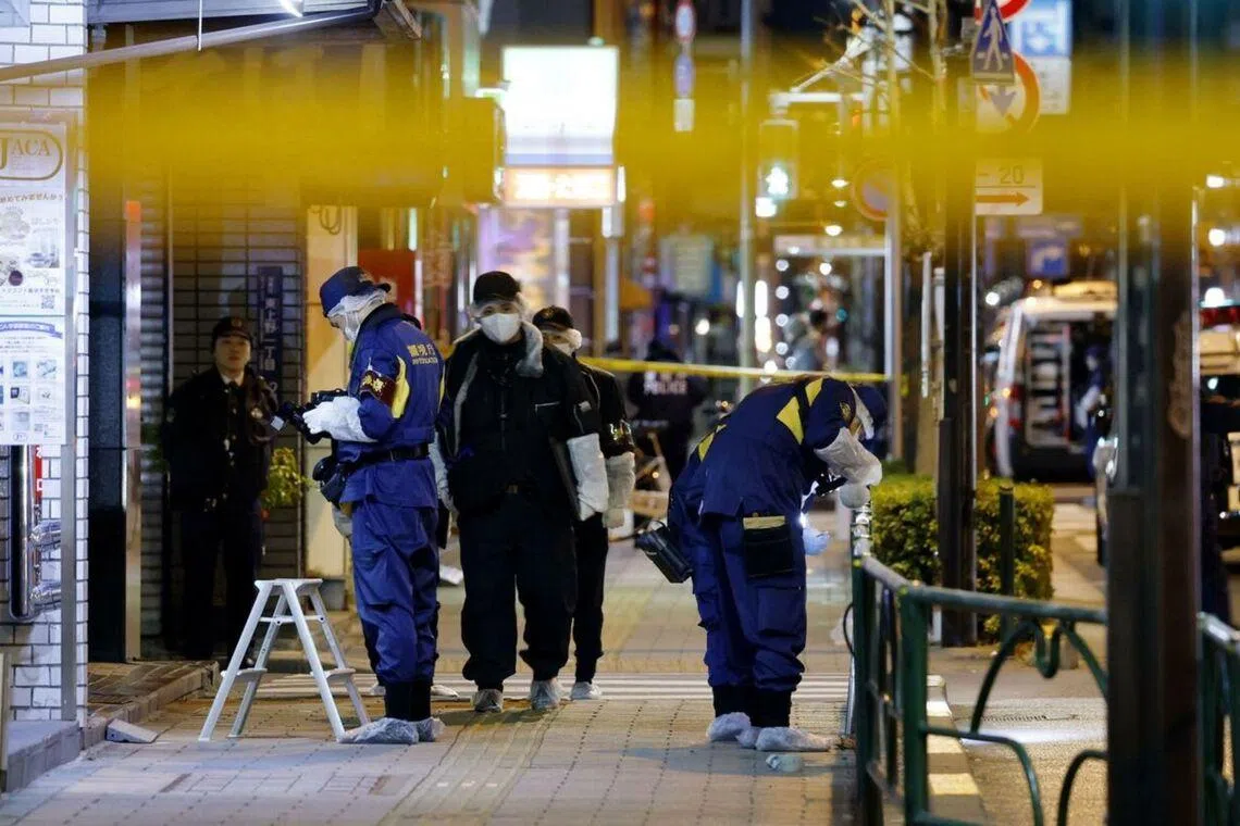 Investigators work in the area of a suspected robbery in Tokyo's Taito ward in the early hours of Jan 30.