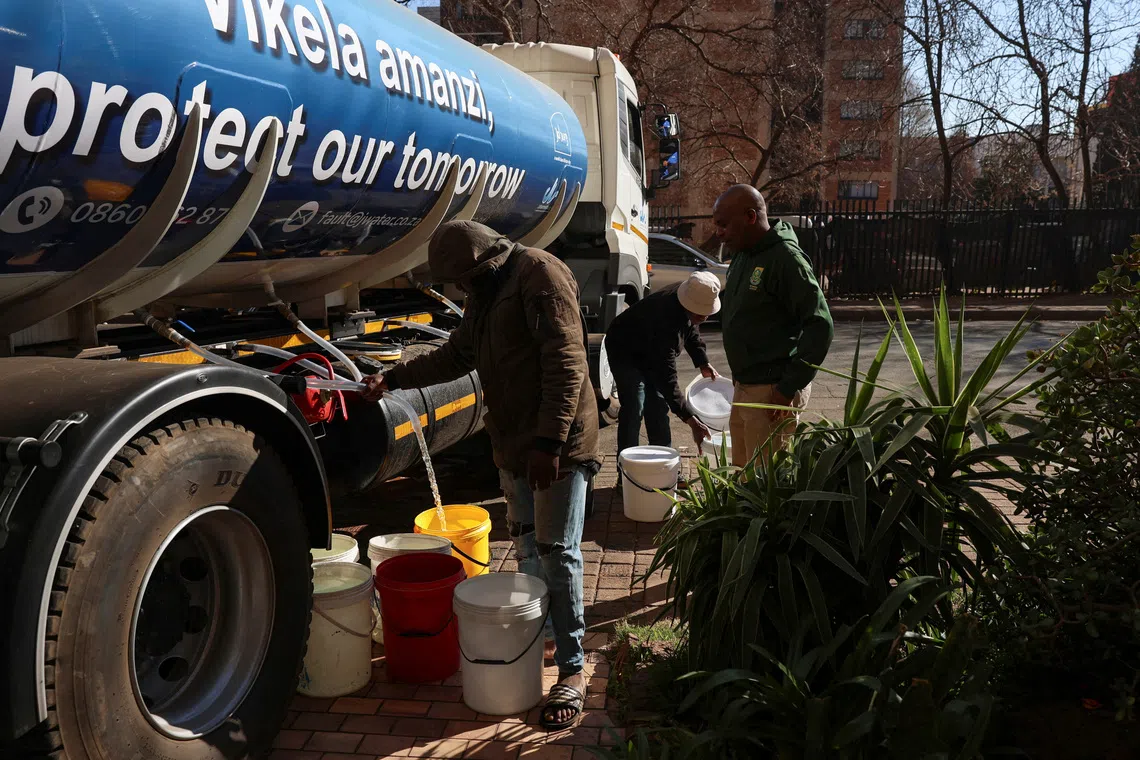 People collecting water from a truck as dry taps have become a daily frustration for residents of Hillbrow on Aug 4.